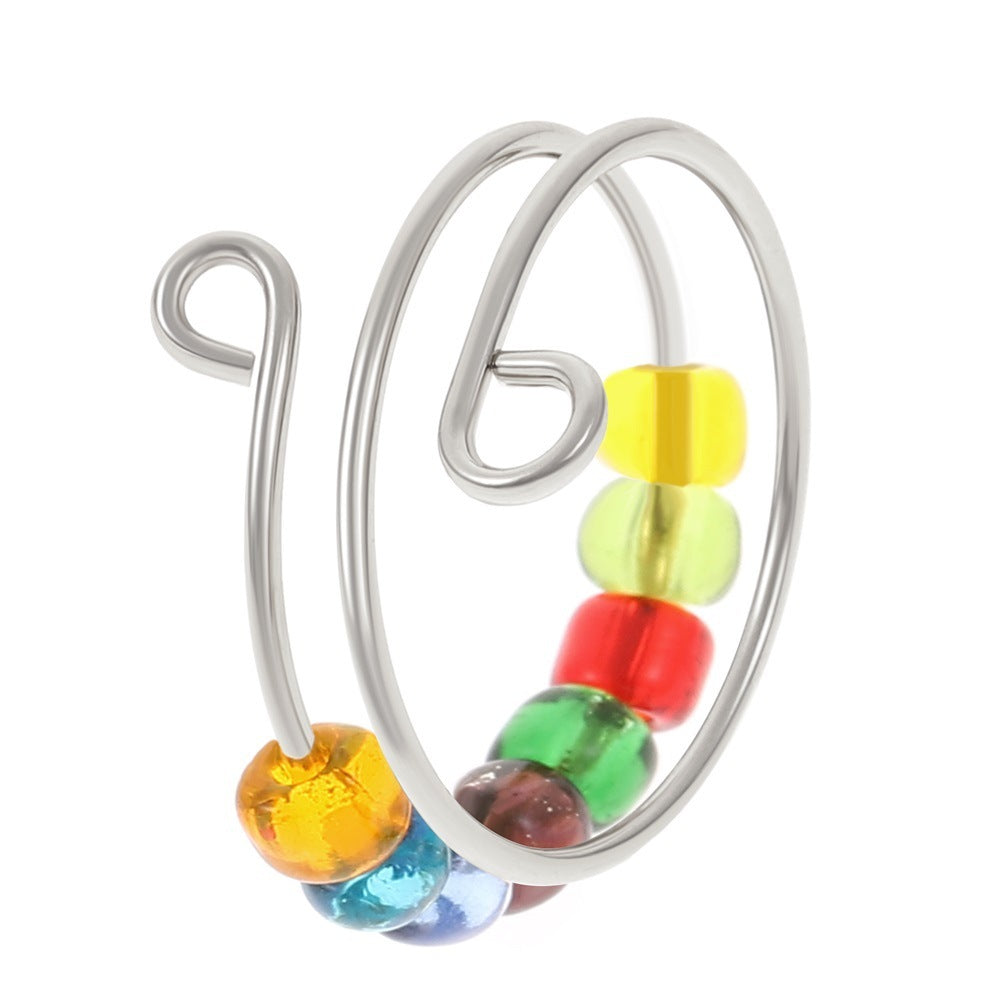 The Adjustable Beaded Crochet & Anxiety Relief Tool is a silver spiral ring with five colorful glass beads—yellow, green, red, blue, and orange—that can be adjusted for comfort.