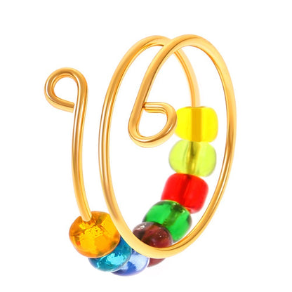 The Adjustable Beaded Crochet & Anxiety Relief Tool is a gold spiral wire ring adorned with yellow, green, red, blue, and orange glass beads—ideal as a yarn tension ring or a fashionable anxiety relief accessory.